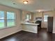 Bright kitchen features dark wood floors, stainless steel appliances, and neutral-toned cabinets at 109 S Maple Ave., Andrews, SC 29510