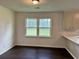 Bright eat-in kitchen with large windows and dark wood flooring at 109 S Maple Ave., Andrews, SC 29510