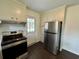 Kitchen with stainless steel appliances and a door leading to the backyard at 109 S Maple Ave., Andrews, SC 29510