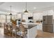 Bright kitchen features a center island with seating, stainless steel appliances, and white cabinetry at 1114 Laconic Dr., Myrtle Beach, SC 29588