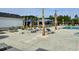 Community pool deck with lounge chairs, picnic tables, palm trees, and shade cabanas at 1114 Laconic Dr., Myrtle Beach, SC 29588