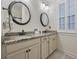 Bathroom featuring a double vanity with granite countertops and decorative round mirrors at 1188 Peterson St., Myrtle Beach, SC 29577