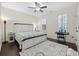 Comfortable bedroom features a cozy bed, plantation shutters, and coordinating rugs at 1188 Peterson St., Myrtle Beach, SC 29577