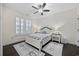 Cozy bedroom features a charming bed, plantation shutters, and coordinating rugs at 1188 Peterson St., Myrtle Beach, SC 29577