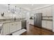 Open kitchen with stainless appliances, granite countertops, and hardwood floors overlooking the living area at 1188 Peterson St., Myrtle Beach, SC 29577