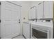 Convenient laundry room with modern washer and dryer, cabinet storage, and easy access to the door at 1188 Peterson St., Myrtle Beach, SC 29577