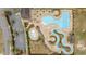 Aerial view of a resort-style pool area with multiple pools, lush landscaping, lounge chairs, and shaded cabanas at 1188 Peterson St., Myrtle Beach, SC 29577