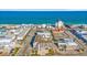 A picturesque aerial view captures oceanfront condos, businesses, and beaches with crystal-clear ocean waters at 120 Dogwood Dr. N # 313, Garden City Beach, SC 29576
