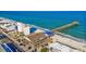 A scenic aerial view captures the oceanfront setting of a charming restaurant and pier on a sunny day at 120 Dogwood Dr. N # 313, Garden City Beach, SC 29576