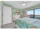Comfortable bedroom with light green walls, TV, and sliding glass door to balcony at 120 Dogwood Dr. N # 313, Garden City Beach, SC 29576