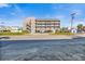 Condo building with beachy vibes and covered parking underneath; convenient for guests and residents at 120 Dogwood Dr. N # 313, Garden City Beach, SC 29576