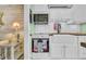 Charming kitchen featuring white cabinets, a farmhouse sink, and a convenient pass-through to the living area at 120 Dogwood Dr. N # 313, Garden City Beach, SC 29576
