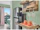 Close up of a kitchen area with a coffee bar, stainless steel refrigerator, and decoratively shelved wine glasses at 120 Dogwood Dr. N # 313, Garden City Beach, SC 29576