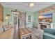 Bright living room with coastal charm, including a decorative trunk, modern TV, and an open view to the kitchen at 120 Dogwood Dr. N # 313, Garden City Beach, SC 29576