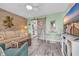 Cozy living room featuring coastal decor, stylish furniture, and a sliding barn door to the kitchen at 120 Dogwood Dr. N # 313, Garden City Beach, SC 29576