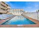 Inviting outdoor pool area with lounge chairs surrounded by a privacy fence at 120 Dogwood Dr. N # 313, Garden City Beach, SC 29576