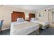 Inviting bedroom with two beds, wooden headboards, stylish lamps, and soft, neutral bedding at 1200 North Ocean Blvd. # 206, Myrtle Beach, SC 29577