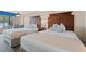 Charming bedroom featuring two beds, a nightstand, and balcony views to the ocean at 1200 North Ocean Blvd. # 206, Myrtle Beach, SC 29577