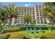 Exterior view of the building with manicured landscaping and lounge seating at 1200 North Ocean Blvd. # 206, Myrtle Beach, SC 29577