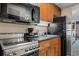 Efficiency kitchenette with stainless steel appliances, granite counters, and wood cabinets at 1200 North Ocean Blvd. # 206, Myrtle Beach, SC 29577