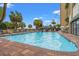 Inviting outdoor pool area with sun loungers and palm trees at 1200 North Ocean Blvd. # 206, Myrtle Beach, SC 29577