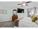 Serene bedroom with dresser, a TV, and sliding glass doors to a balcony at 1217 S Ocean Blvd. # 5, Surfside Beach, SC 29575