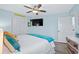 Airy bedroom featuring a king-size bed, a ceiling fan, and a spacious closet at 1217 S Ocean Blvd. # 5, Surfside Beach, SC 29575