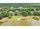 Aerial view of a home nestled next to a lush golf course and tranquil lake, offering a serene setting at 124 Turtle Creek Dr., Pawleys Island, SC 29585