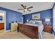 Spacious bedroom with large bed, ceiling fan, and blue accent wall at 124 Turtle Creek Dr., Pawleys Island, SC 29585