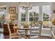 Dining area with natural light, wood table and seating with backyard view at 124 Turtle Creek Dr., Pawleys Island, SC 29585