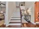 Elegant foyer showcasing a staircase with wood and iron accents and a stylish console table at 124 Turtle Creek Dr., Pawleys Island, SC 29585