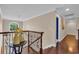 Hallway with rich hardwood floors and decorative wrought iron railing at 124 Turtle Creek Dr., Pawleys Island, SC 29585