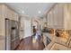Modern kitchen with stainless steel appliances, granite countertops, and dark hardwood flooring at 124 Turtle Creek Dr., Pawleys Island, SC 29585