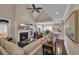 Cozy living room features a fireplace with an inset TV, plush seating and hardwood flooring at 124 Turtle Creek Dr., Pawleys Island, SC 29585