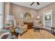 Cozy living room with patterned armchairs, a ceiling fan, and a view into the bathroom at 124 Turtle Creek Dr., Pawleys Island, SC 29585