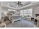 Bright main bedroom showcasing large window and trey ceiling with fan at 124 Turtle Creek Dr., Pawleys Island, SC 29585