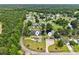 An aerial view of homes on a pond with large lawn at 131 Pine Lake Circle, Ocean Isle Beach, NC 28469