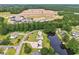 An aerial view of homes on a pond near construction at 131 Pine Lake Circle, Ocean Isle Beach, NC 28469