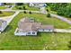 A home sitting on a large lot with a well manicured lawn next to a small pond at 131 Pine Lake Circle, Ocean Isle Beach, NC 28469