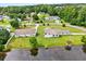 An aerial view of a beautiful neighborhood with a home sitting next to the pond at 131 Pine Lake Circle, Ocean Isle Beach, NC 28469