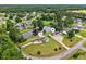 A panoramic aerial view showcasing a pond surrounded by residential properties at 131 Pine Lake Circle, Ocean Isle Beach, NC 28469
