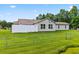 A spacious backyard with a white wooden fence and a pond next to the chain link fence at 131 Pine Lake Circle, Ocean Isle Beach, NC 28469