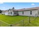 Large backyard with a green lawn, surrounded by a chain link fence at 131 Pine Lake Circle, Ocean Isle Beach, NC 28469