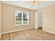Cozy bedroom with wood floors, window views, and an open closet for storage at 131 Pine Lake Circle, Ocean Isle Beach, NC 28469