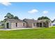 Charming single-story brick home featuring a lush green lawn and mature trees at 131 Pine Lake Circle, Ocean Isle Beach, NC 28469