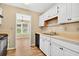 Clean kitchen with white cabinets, laminate countertops, and modern appliances opening to the living area at 131 Pine Lake Circle, Ocean Isle Beach, NC 28469