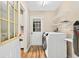 Convenient laundry room with modern appliances, built-in shelving, and access to the backyard at 131 Pine Lake Circle, Ocean Isle Beach, NC 28469