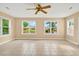 Spacious living room boasting tile flooring, ceiling fan, and two large windows for ample light at 131 Pine Lake Circle, Ocean Isle Beach, NC 28469