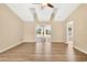 Open living room with vaulted ceilings, modern flooring, and sliding glass doors to the outdoor space at 131 Pine Lake Circle, Ocean Isle Beach, NC 28469