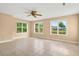 Inviting living room featuring tile flooring, a ceiling fan, and an exterior view at 131 Pine Lake Circle, Ocean Isle Beach, NC 28469
